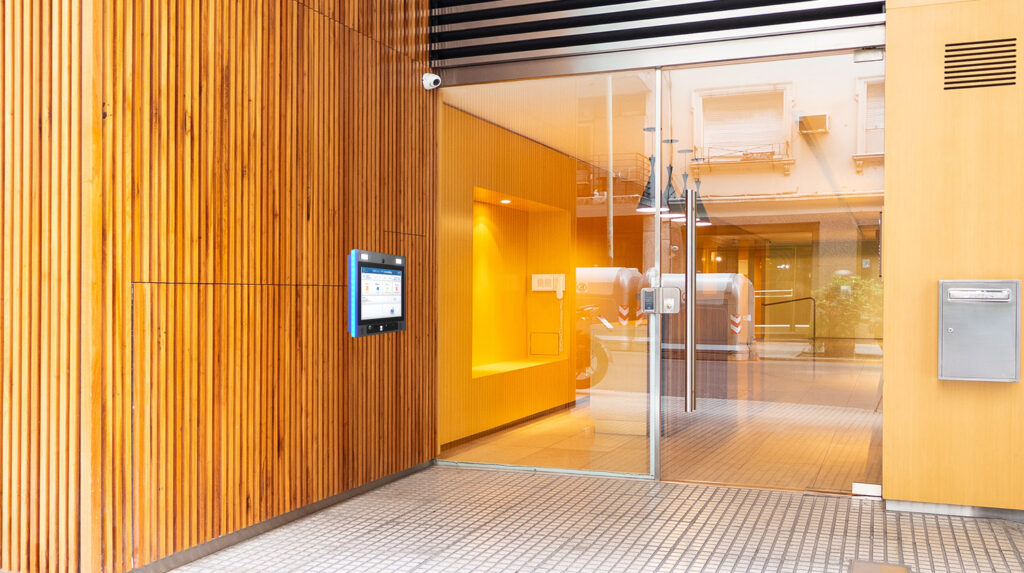 mvi keycom system mounted on wood wall by building entrance