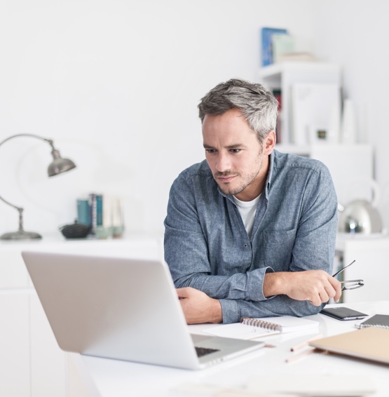 man working on laptop in home office