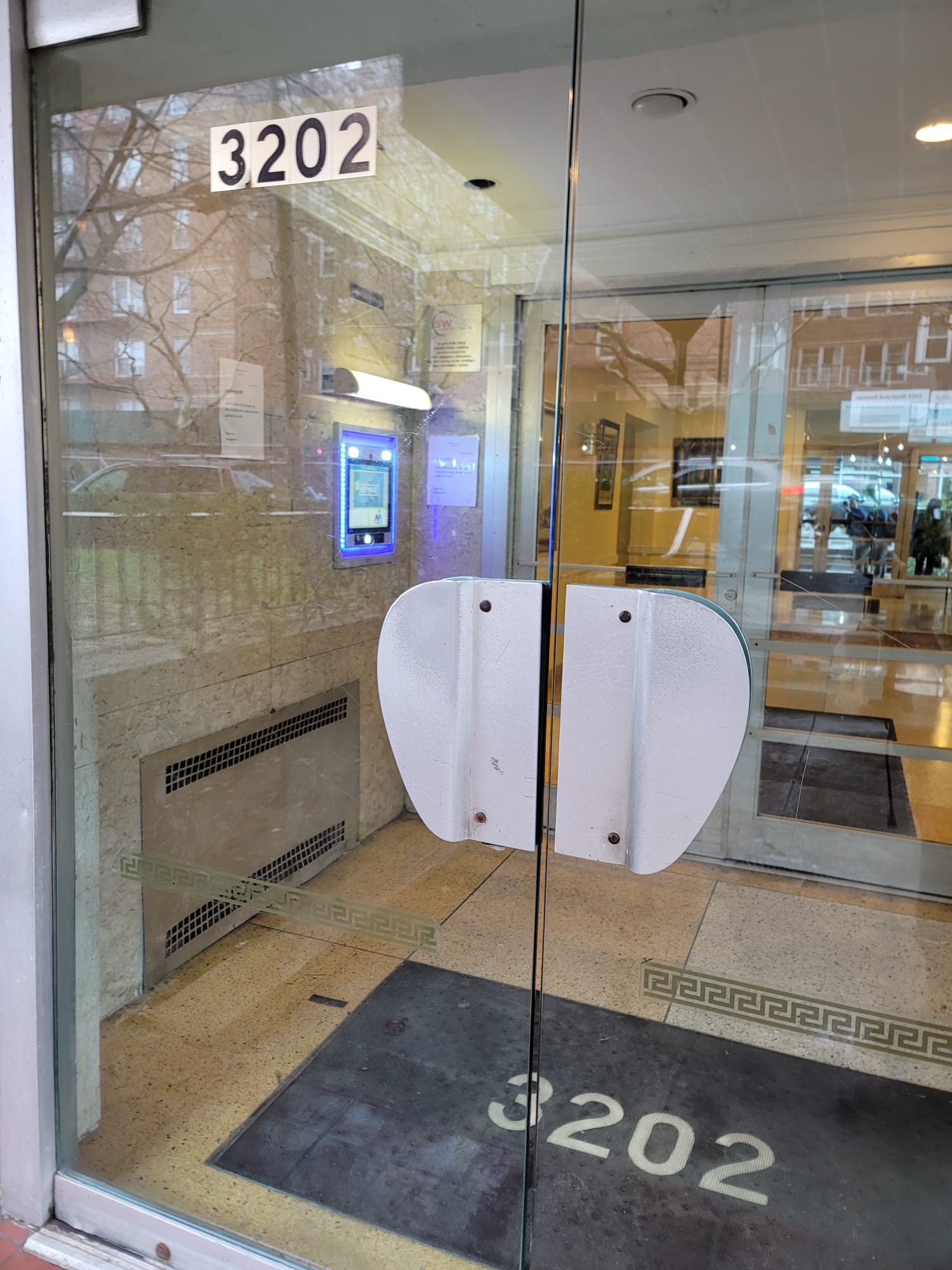 mvi keycom mounted on marble wall by building entrance
