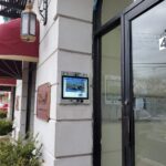 mvi keycom mounted on white stone wall by apartment building entrance