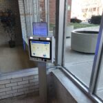 mvi keycom mounted on metal stand inside of building