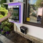 person using mvi access system to enter building