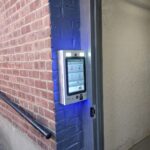 mvi keycom mounted on brick wall by building entrance