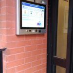 mvi keycom mounted on brick wall next to building entrance