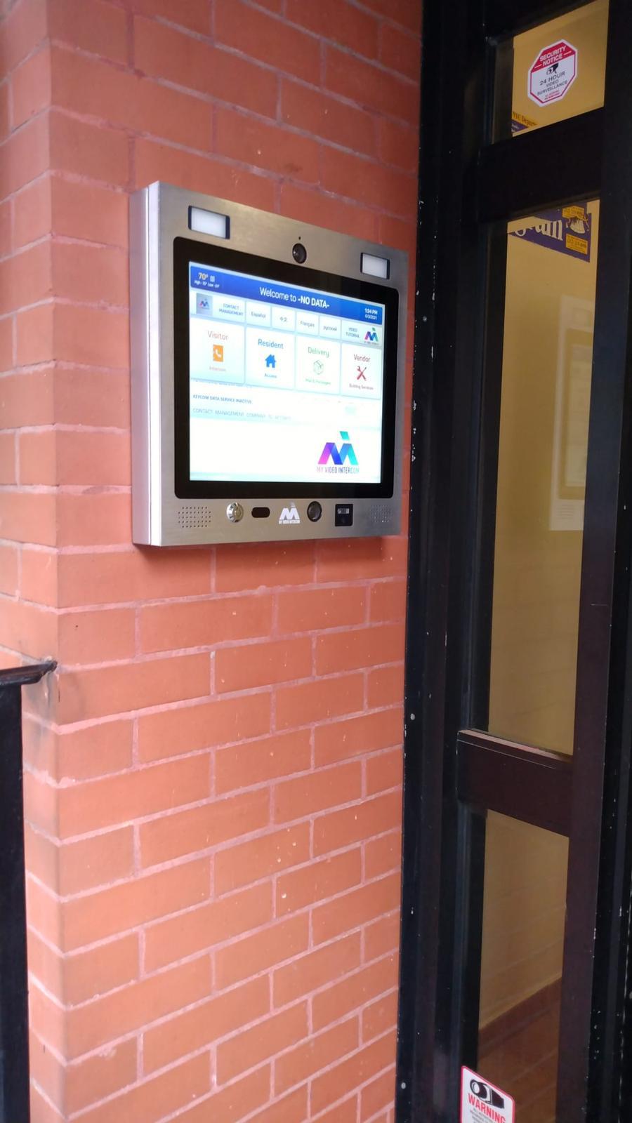 mvi keycom mounted on brick wall next to building entrance