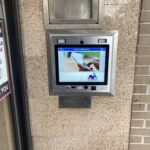 mvi keycom mounted on wall by building entrance