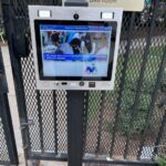 mvi keycom mounted on metal stand by gated entrance