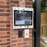 mvi keycom mounted on brick wall by building entrance