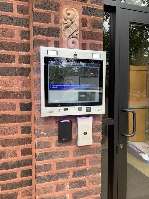 mvi keycom mounted on brick wall by building entrance
