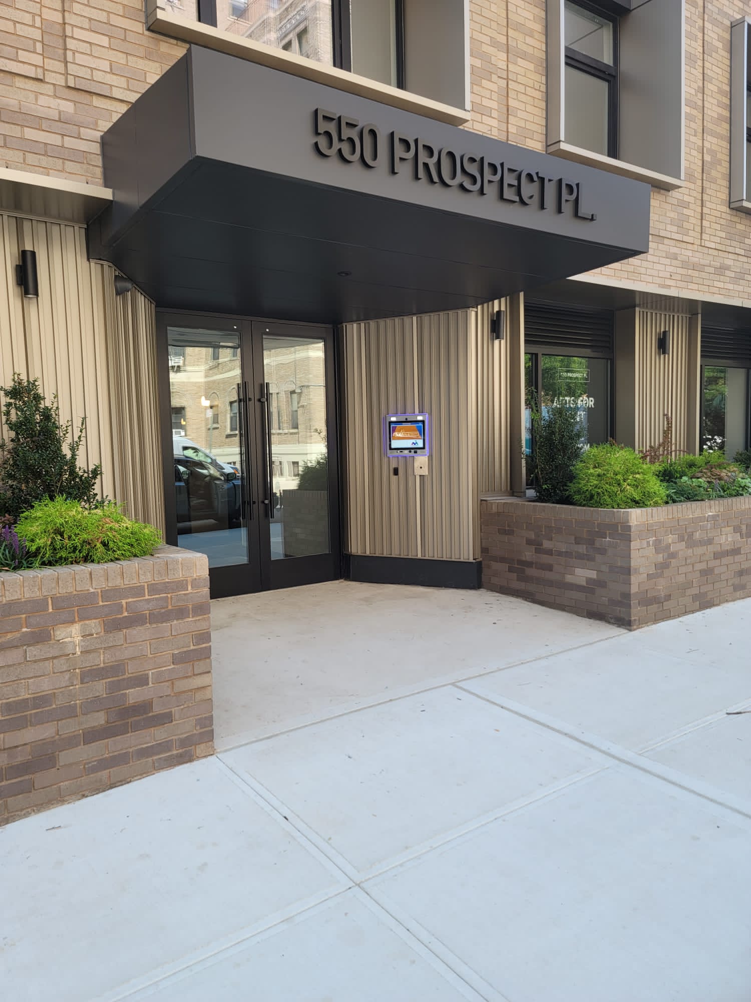 mvi keycom mounted on wall by office building entrance