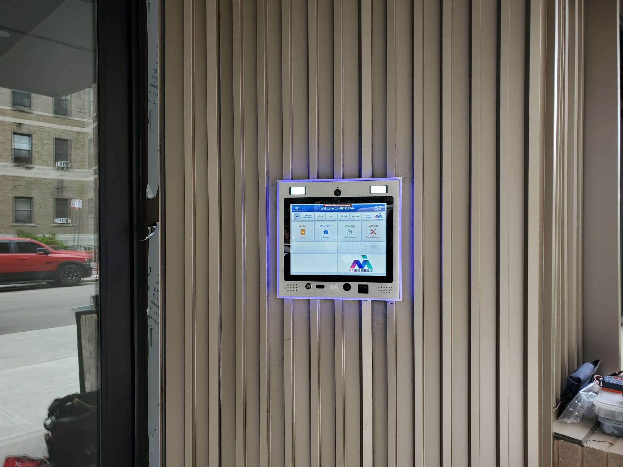 mvi keycom mounted on metal wall by building entrance