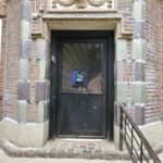 mvi keycom system mounted on wall inside of main stone building entrance