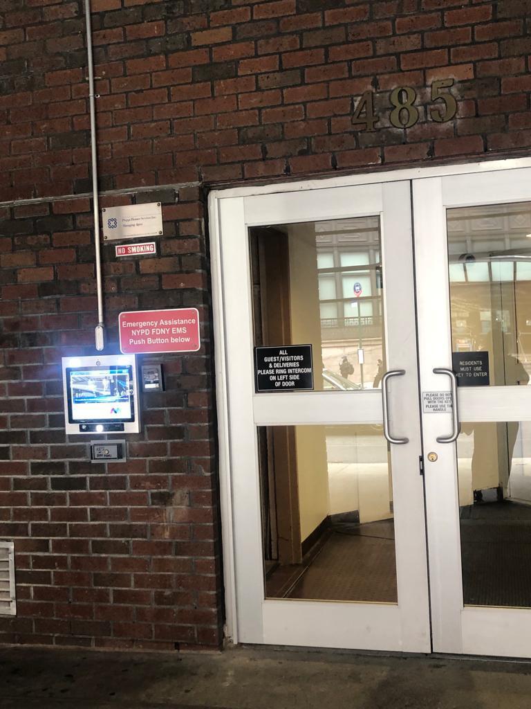 mvi keycom system mounted on brick wall by building entrance