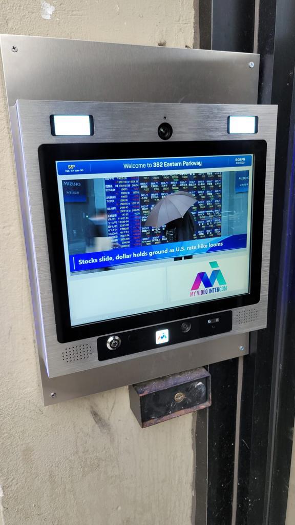 mvi keycom system mounted on wall by building entrance