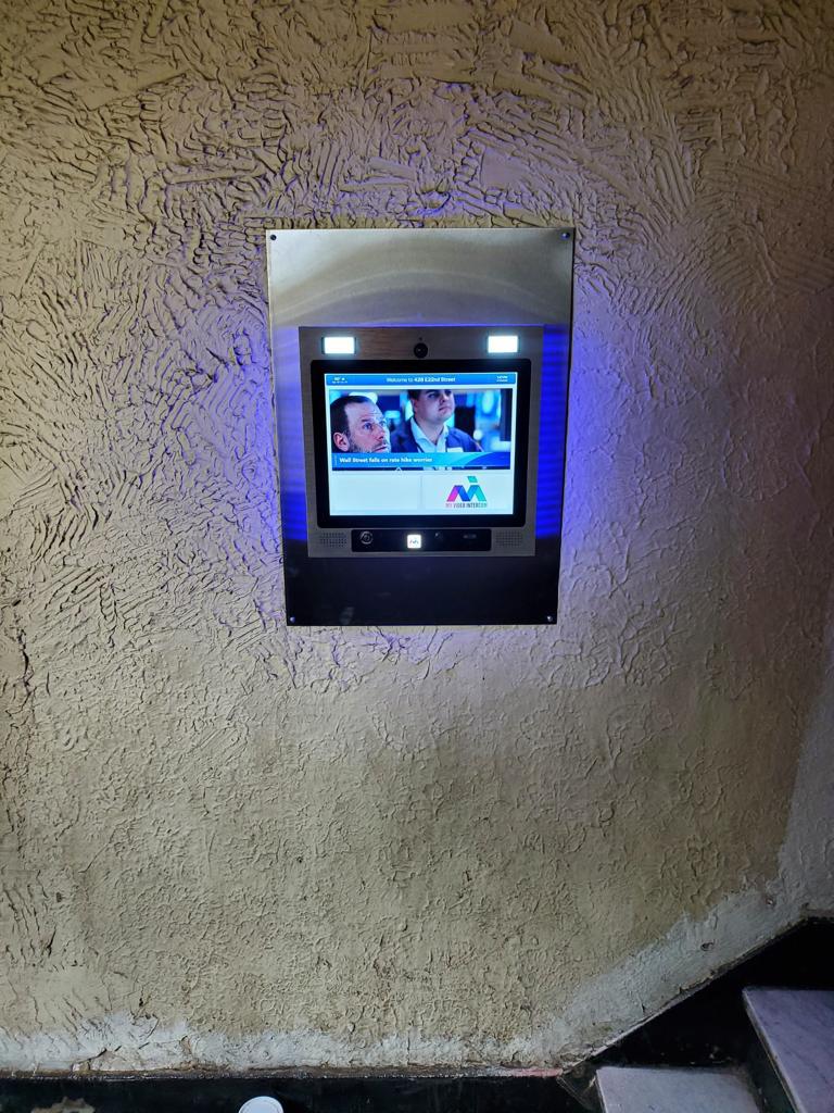 mvi keycom system mounted on wall by building entrance