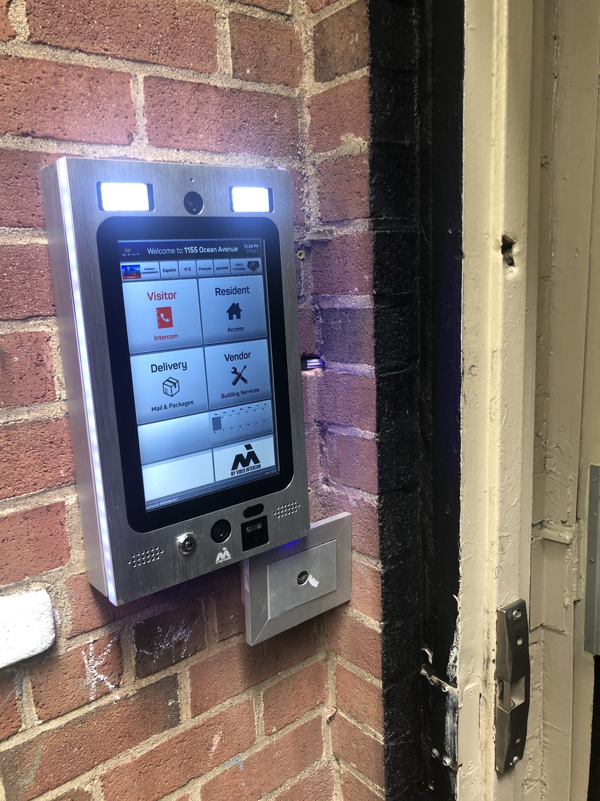 mvi keycom mounted on brick wall by building entrance