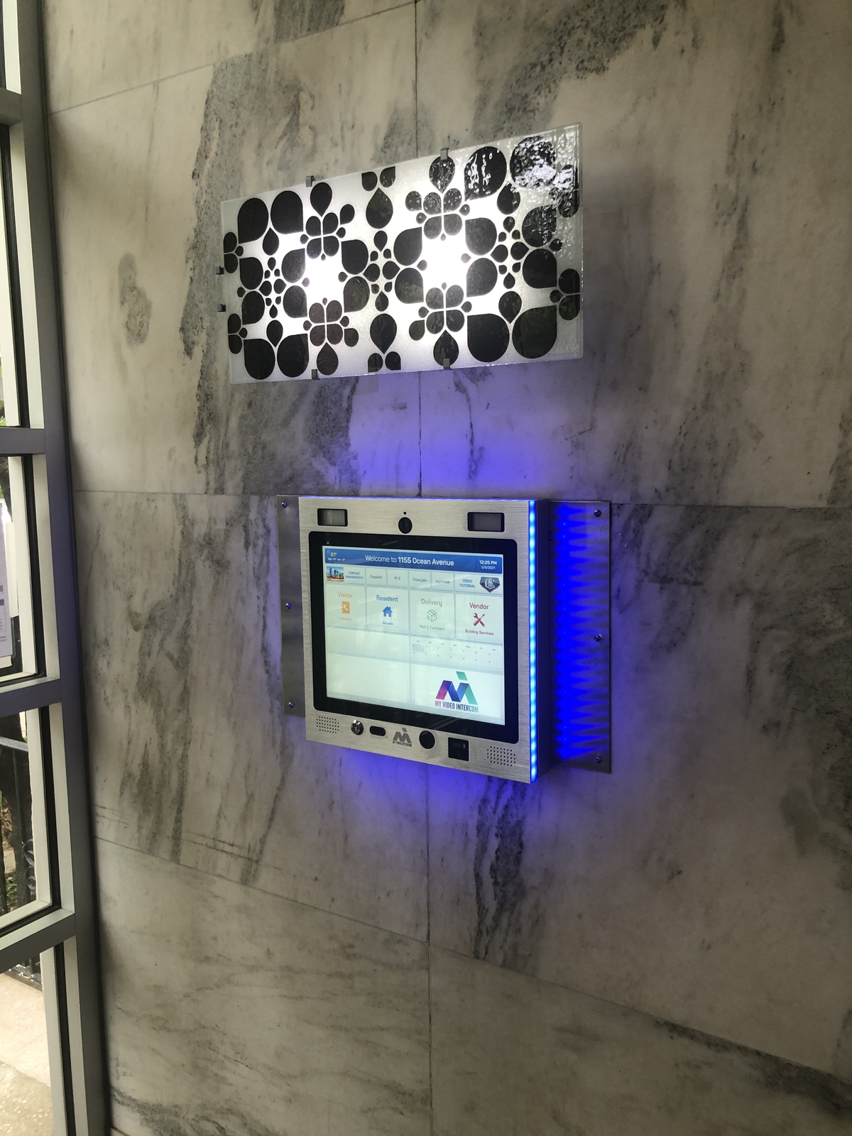 mvi keycom mounted on stone wall by building entrance