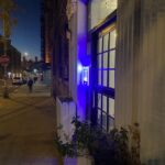 mvi keycom mounted on wall next to building entrance at night