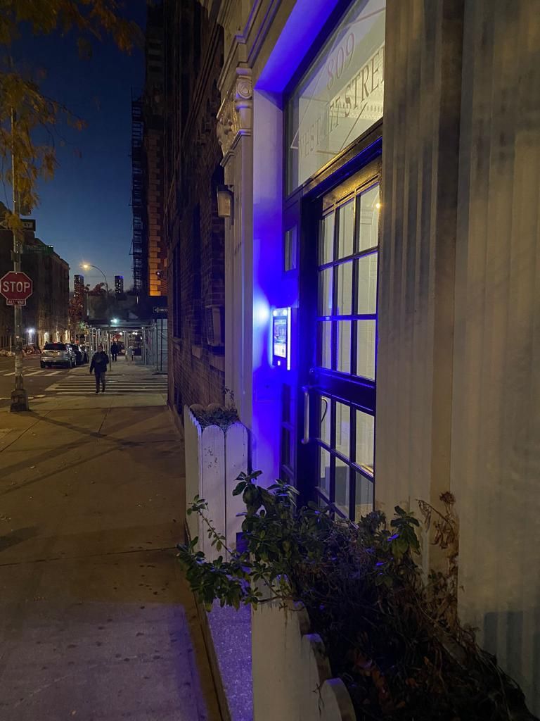 mvi keycom mounted on wall next to building entrance at night