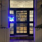 mvi keycom mounted on glass door by apartment building entrance