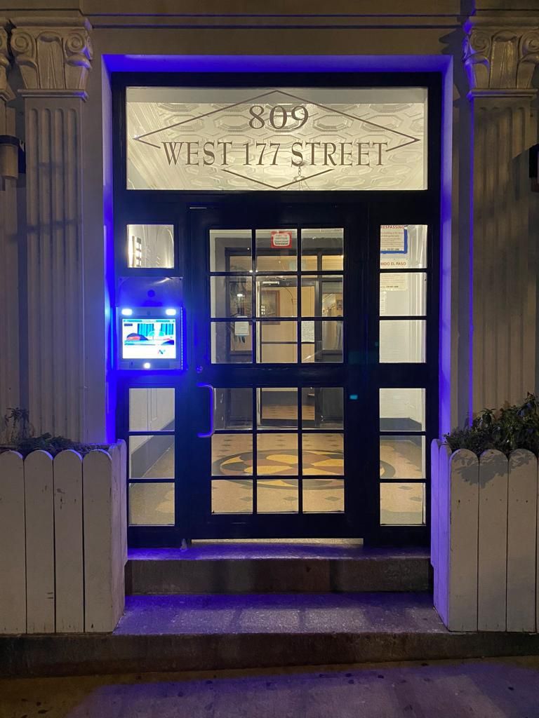 mvi keycom mounted on glass door by apartment building entrance