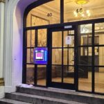 mvi keycom mounted on glass door by apartment building entrance