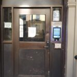 mvi keycom system mounted on metal door by building entrance