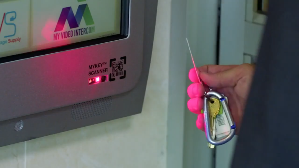 person using mykey scanner on keycom for building access