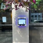 mvi access system installed on white brick column by building entrance