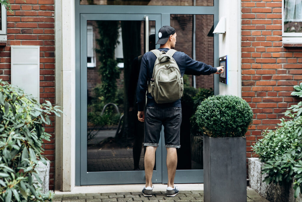 college student ringing keycom doorbell for building access